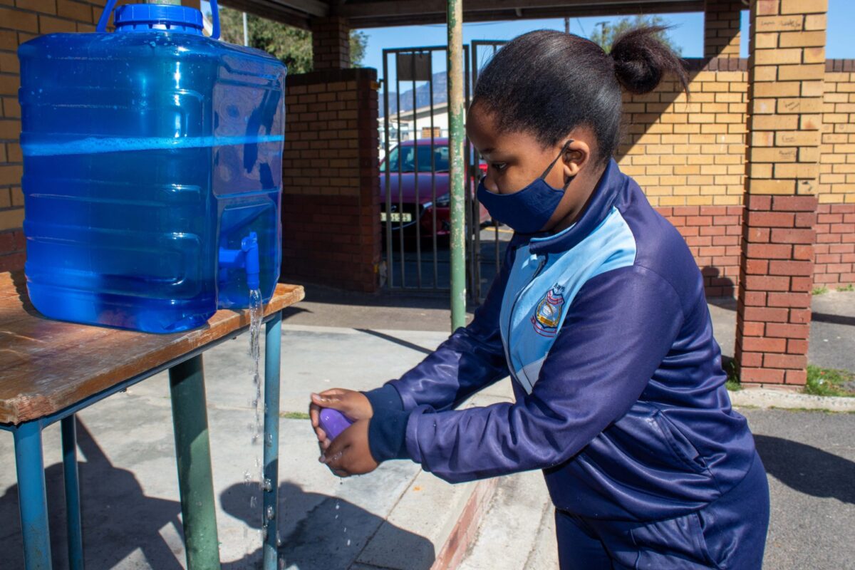 Ezam Bopape, a learner at Surrey Primary School using one of the soap bars donated to her school.